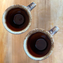 Load image into Gallery viewer, Pair of vintage glossy brown drip glaze mugs. Crafted by Hull Pottery, USA, 1960s. Enjoy any hot beverage in this fabulous retro oven-proof tableware!

In excellent condition, no chips/cracks/repairs. Maker&#39;s marks.

Measures 3 3/4x 3 1/2 inches

Capacity 8 ounces
