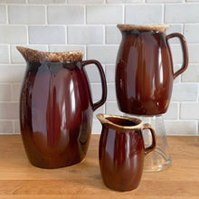 Load image into Gallery viewer, Set of three vintage glossy brown drip glazed ceramic pitcher. Crafted by Hull Pottery, USA, 1960s. A beautiful set to add to your home decor or art pottery collection!

In excellent condition, no chips/cracks/repairs. Maker&#39;s marks.

Measurements

Large: 5 x 9 inches, 72 ounces

Medium: 4 x 6 3/4 inches, 32 ounces

Small: 2 3/4 x 4 1/2 inches, 8 ounces
