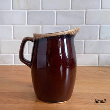Load image into Gallery viewer, Vintage glossy brown drip glazed ceramic pitcher. Crafted by Hull Pottery, USA, 1960s. A beautiful piece to add to your home decor or art pottery collection!

In excellent condition, no chips/cracks/repairs. Maker&#39;s marks.

Measurements

Small: 2 3/4 x 4 1/2 inches, 8 ounces
