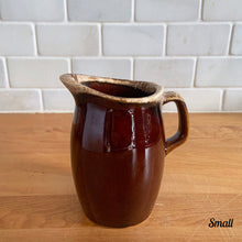 Load image into Gallery viewer, Vintage glossy brown drip glazed ceramic pitcher. Crafted by Hull Pottery, USA, 1960s. A beautiful piece to add to your home decor or art pottery collection!

In excellent condition, no chips/cracks/repairs. Maker&#39;s marks.

Measurements

Small: 2 3/4 x 4 1/2 inches, 8 ounces
