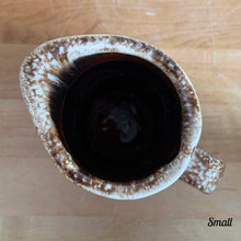 Load image into Gallery viewer, Vintage glossy brown drip glazed ceramic pitcher. Crafted by Hull Pottery, USA, 1960s. A beautiful piece to add to your home decor or art pottery collection!

In excellent condition, no chips/cracks/repairs. Maker&#39;s marks.

Measurements

Small: 2 3/4 x 4 1/2 inches, 8 ounces
