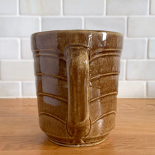Load image into Gallery viewer, Vintage gloss brown stoneware pitcher with stacked chevron detail. Crafted by Monmouth Western Stoneware, USA, 1920s. Add this utilitarian piece to your farmhouse decor or art pottery collection!

In excellent vintage condition, no chips/cracks/repairs, age-related crazing. Unmarked.

Measures 4 1/2 x 5 inches
