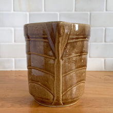 Load image into Gallery viewer, Vintage gloss brown stoneware pitcher with stacked chevron detail. Crafted by Monmouth Western Stoneware, USA, 1920s. Add this utilitarian piece to your farmhouse decor or art pottery collection!

In excellent vintage condition, no chips/cracks/repairs, age-related crazing. Unmarked.

Measures 4 1/2 x 5 inches
