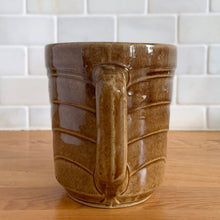 Load image into Gallery viewer, Vintage gloss brown stoneware pitcher with stacked chevron detail. Crafted by Monmouth Western Stoneware, USA, 1920s. Add this utilitarian piece to your farmhouse decor or art pottery collection!

In excellent vintage condition, no chips/cracks/repairs, age-related crazing. Unmarked.

Measures 4 1/2 x 5 inches
