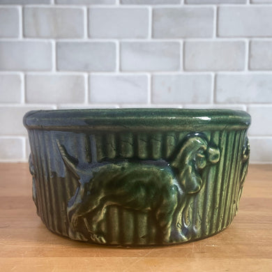 Vintage glossy green yellow ware dog food bowl embossed with vertical ribs and different dog breeds. Crafted by Robinson Ransbottom Pottery Co., Roseville, 1920s. A rare piece to add to your art pottery collection or farmhouse kitchen decor!

In excellent condition, no chips/cracks/repairs, typical manufacturing glaze pops, pottery bits and crazing. Maker's marks.

Measures 6 x 2 7/8 inches