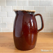 Load image into Gallery viewer, Vintage glossy brown drip glazed ceramic pitcher. Crafted by Hull Pottery, USA, 1960s. A beautiful piece to add to your home decor or art pottery collection!

In excellent condition, no chips/cracks/repairs. Maker&#39;s marks.

Measurements

Medium: 4 x 6 3/4 inches, 32 ounces
