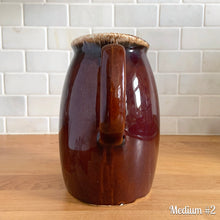Load image into Gallery viewer, Vintage glossy brown drip glazed ceramic pitcher. Crafted by Hull Pottery, USA, 1960s. A beautiful piece to add to your home decor or art pottery collection!

In excellent condition, no chips/cracks/repairs. Maker&#39;s marks.

Measurements

Medium: 4 x 6 3/4 inches, 32 ounces

