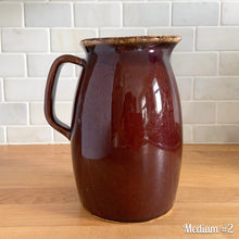 Load image into Gallery viewer, Vintage glossy brown drip glazed ceramic pitcher. Crafted by Hull Pottery, USA, 1960s. A beautiful piece to add to your home decor or art pottery collection!

In excellent condition, no chips/cracks/repairs. Maker&#39;s marks.

Measurements

Medium: 4 x 6 3/4 inches, 32 ounces
