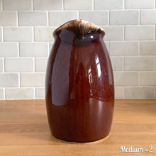 Load image into Gallery viewer, Vintage glossy brown drip glazed ceramic pitcher. Crafted by Hull Pottery, USA, 1960s. A beautiful piece to add to your home decor or art pottery collection!

In excellent condition, no chips/cracks/repairs. Maker&#39;s marks.

Measurements

Medium: 4 x 6 3/4 inches, 32 ounces
