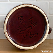 Load image into Gallery viewer, Vintage glossy brown drip glazed ceramic pitcher. Crafted by Hull Pottery, USA, 1960s. A beautiful piece to add to your home decor or art pottery collection!

In excellent condition, no chips/cracks/repairs. Maker&#39;s marks.

Measurements

Medium: 4 x 6 3/4 inches, 32 ounces
