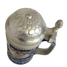 Load image into Gallery viewer, Overhead view of the full stein with pewter lid closed, showing embossed floral detail and acorn finial
