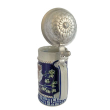 Load image into Gallery viewer, Handle view of the full stein with pewter lid open, cobalt blue body, three baby owls on branches relief, rope border, and geometric base band

