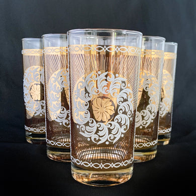 Stunning set of eight Vintage mid-century luxury highball glass tumblers, decorated with a 24 karat gold starburst, gold floral decorative white sugar texture wreath, a gold border overlayed with an atomic pattern, also in white sugar texture. Crafted by the talented designers of the Libbey Glass Company, USA, circa 1950s/60s. These beauties will add an exquisite touch to any occasion - indulge your guests with these truly special cocktail glasses.