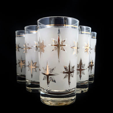 Set of six vintage highball cocktail glasses featuring gold atomic starbursts on a frosted band bordered by gold bands. Crafted by Dominion Glass, Canada, circa 1960s. Stoked with sophisticated style, these will add a special touch of mid-century glamour to your barware!  In vintage condition, no chips.  Measures 2 5/8 x 4 7/8 inches  Capacity 8 ounces