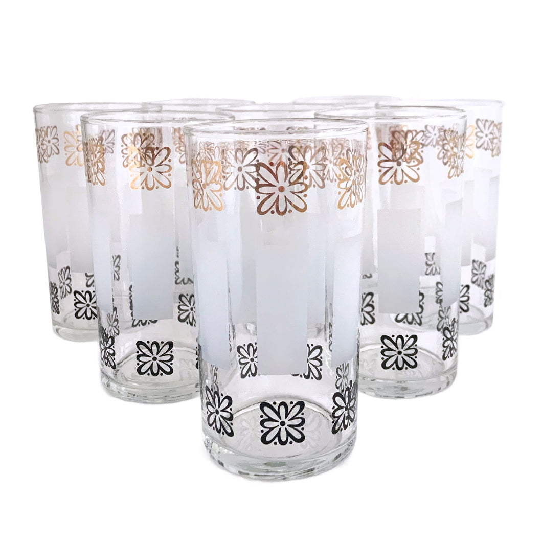 Sip in style with vintage mid-century highball cocktail glass tumblers featuring gold and black atomic style flowers with frosted bands! These elegant glasses from the Libbey Glass Company, USA, circa 1950s are sure to make a statement at your next dinner party. Enjoy the unique blend of classic mid-century style and modern vibrancy in each glass!