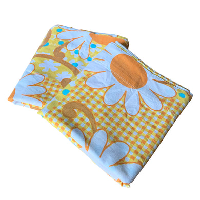 Pair of vintage Gold Country Fair 100% cotton pillowcases featuring a flower power design of daisy and gingham in shades of orange, yellow, blue, avocado green and white. Crafted by Elegance, Canada, 1974. A beautiful addition to your retro boho bedding decor, or repurpose for crafting.

In excellent vintage condition, no stains/tears. Colours are vibrant.

Measures 19 3/4 x 30 inches