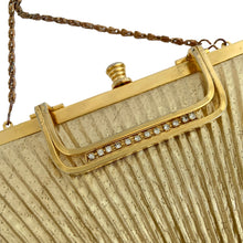 Load image into Gallery viewer, Vintage gold lame fabric Art Deco evening bag. Hong Kong. Its pleated design, chain strap, and gold toned clasp and handle with rhinestone detail create a shimmering display. Its yellow satin lining and interior pocket ensure your belongings stay safe and organized. In good vintage condition, minor tear on the interior lining with wear commensurate with age. Bag measures 9 3/4 x 6 1/4 inches (at widest point, not including handle) Chain measures 40 inches
