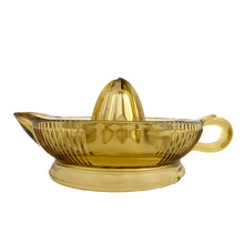 Load image into Gallery viewer, Vintage gold vertically ribbed citrus reamer with spout and finger handle. Crafted by Anchor Hocking, 1950/60s. The perfect accessory for kitchen and bar for fresh squeezed orange, lemon and lime juice...no sugar added!

In vintage condition, rough mold release at the spout, chip to the underside interior rim.

Measures 6 x 8 1/2 x 4 inches (incl. handle/spout)
