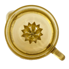Load image into Gallery viewer, Vintage gold vertically ribbed citrus reamer with spout and finger handle. Crafted by Anchor Hocking, 1950/60s. The perfect accessory for kitchen and bar for fresh squeezed orange, lemon and lime juice...no sugar added!

In vintage condition, rough mold release at the spout, chip to the underside interior rim.

Measures 6 x 8 1/2 x 4 inches (incl. handle/spout)

