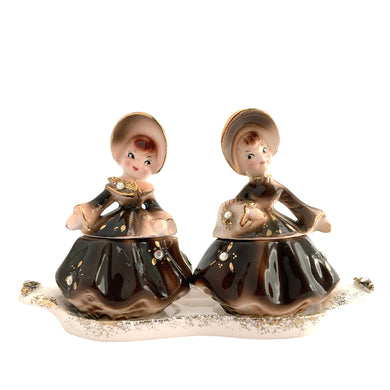 Vintage hand painted Golden Girl ceramic condiment set with tray. Enesco, Japan, 1960s. Add this pretty set to your collection!

In excellent condition, no chips/cracks/repairs.

Each girl measures 2 1/2 x 1 7/8 x 3 1/2 inches

Tray measures 6 1/4 x 2 1/8 inches