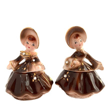 Load image into Gallery viewer, Vintage hand painted Golden Girl ceramic condiment set with tray. Enesco, Japan, 1960s. Add this pretty set to your collection!

In excellent condition, no chips/cracks/repairs.

Each girl measures 2 1/2 x 1 7/8 x 3 1/2 inches

Tray measures 6 1/4 x 2 1/8 inches
