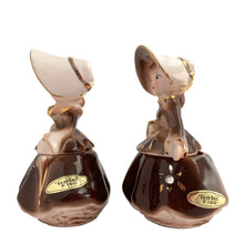 Load image into Gallery viewer, Vintage hand painted Golden Girl ceramic condiment set with tray. Enesco, Japan, 1960s. Add this pretty set to your collection!

In excellent condition, no chips/cracks/repairs.

Each girl measures 2 1/2 x 1 7/8 x 3 1/2 inches

Tray measures 6 1/4 x 2 1/8 inches
