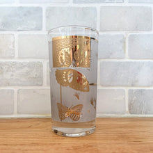 Load image into Gallery viewer, A chilled cocktail would complement this vibrant vintage &quot;Golden Meadow&quot; highball glass tumbler featuring 22kt gold. Designed by Mira and produced by the Federal Glass, USA, circa 1960-70. The gold butterfly and botanical details pop off the frosted background.  In excellent condition, free from chips or cracks. Minor spot of wear on one glass.  Measures 2 3/4 x 5 1/8 inches 
