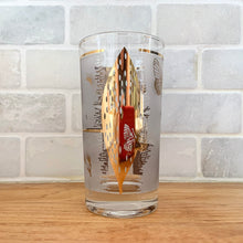 Load image into Gallery viewer, A chilled cocktail would complement this vibrant vintage &quot;Golden Meadow&quot; highball glass tumbler featuring 22kt gold. Designed by Mira and produced by the Federal Glass, USA, circa 1960-70. The gold butterfly and botanical details pop off the frosted background.  In excellent condition, free from chips or cracks. Minor spot of wear on one glass.  Measures 2 3/4 x 5 1/8 inches 
