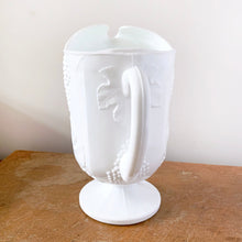 Load image into Gallery viewer, The words &quot;stunning&quot; and &quot;elegant&quot; embody this incredible milk glass pitcher in the &quot;Harvest&quot; pattern of grapes and vines. This is the largest version in this series holding 72oz. Made by Colony (Indiana) Glass Co. Circa 1966. This pitcher would look amazing on any tablescape or use it for a beautiful floral bouquet.  In excellent condition, no chips or cracks.  Measures 6 x 10 3/8 inches
