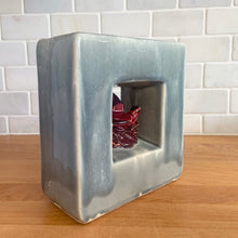 Load image into Gallery viewer, Vintage mid-century gray Arcature Line vase with central deep red bird. Crafted by McCoy Pottery, USA, early 1950s. This rare piece is must for any art pottery collector!

In excellent condition, no chips/cracks/repairs. Maker&#39;s mark.

Measures 6 1/4 x 2 7/8 x 6 1/2 inches
