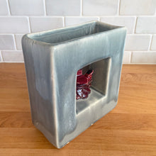 Load image into Gallery viewer, Vintage mid-century gray Arcature Line vase with central deep red bird. Crafted by McCoy Pottery, USA, early 1950s. This rare piece is must for any art pottery collector!

In excellent condition, no chips/cracks/repairs. Maker&#39;s mark.

Measures 6 1/4 x 2 7/8 x 6 1/2 inches
