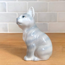 Load image into Gallery viewer, Delightful vintage gray tabby cat porcelain figurine. Crafted by Otagiri, Japan. Add this sweet figurine to your collection!

In excellent condition, no chips/cracks.

Measures 2 1/4 x 1 5/8 x 3 1/2 inches
