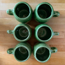 Load image into Gallery viewer, Vintage green barrel ceramic mugs and tankard pitcher set, includes six mugs and and one pitcher. Crafted by McCoy Pottery, USA, 1920s. Off the hop this set gives us all the beer, hot chocolate and cider vibes!

In excellent condition, no chips/cracks/repairs.

Mugs measure 3 3/4 x 4 5/8 inches. Capacity 18oz

Tankard Pitcher measures 5 1/4 x 8 inches. Capacity 72oz
