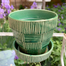 Load image into Gallery viewer, Highly collectible vintage mid-century green basketweave ceramic art pottery planter with attached underplate. Crafted by McCoy Pottery, USA, 1950s. The perfect home for your favourite houseplant or succulent. Makes a lovely gift for any gardening enthusiast.

In excellent vintage condition, no chips/cracks/repairs, age-related crazing. Maker's mark.

Measures 5 1/4 x 4 7/8 inches
