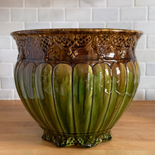 Load image into Gallery viewer, Large antique Majolica jardiniere planter featuring a vibrant drip glaze in green and ochre, vertically ribbed body with embossed details at the base and rim. Crafted by Roseville Pottery, 1920s. A stunning piece of art pottery to add sophisticated charm to your home decor!

In excellent vintage condition, no chips/cracks/repairs. Minor hard water residue. Typical manufacturer&#39;s glaze pops and age-related crazing. Unmarked.

Measures 11 7/8 x 9 3/4 inches
