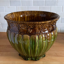 Load image into Gallery viewer, Large antique Majolica jardiniere planter featuring a vibrant drip glaze in green and ochre, vertically ribbed body with embossed details at the base and rim. Crafted by Roseville Pottery, 1920s. A stunning piece of art pottery to add sophisticated charm to your home decor!

In excellent vintage condition, no chips/cracks/repairs. Minor hard water residue. Typical manufacturer&#39;s glaze pops and age-related crazing. Unmarked.

Measures 11 7/8 x 9 3/4 inches
