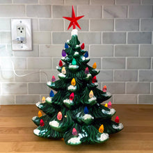 Load image into Gallery viewer, Vintage green ceramic Christmas tree with snowy bough tips, colourful plastic bulbs, star and new electrical cord with LED bulb. Circa 1970s. A lovely way to add some nostalgia to your Christmas holiday home decor!  In excellent condition, free from chips  Measures 9 x 10 1/2 inches
