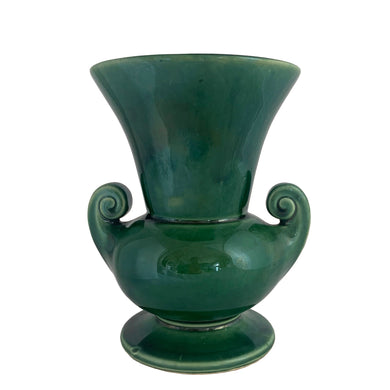 Vintage mid-century gloss green trumpet vase with curled handles. Crafted by McCoy Pottery, late 1950s. This lovely vase is must for any art pottery collector!

In excellent  condition, no chips/cracks/repairs, crazing commensurate with age, typical manufacturing glaze pops. Maker's mark on the bottom.

Measures 6 1/4 x 5 7/8 x 8 inches