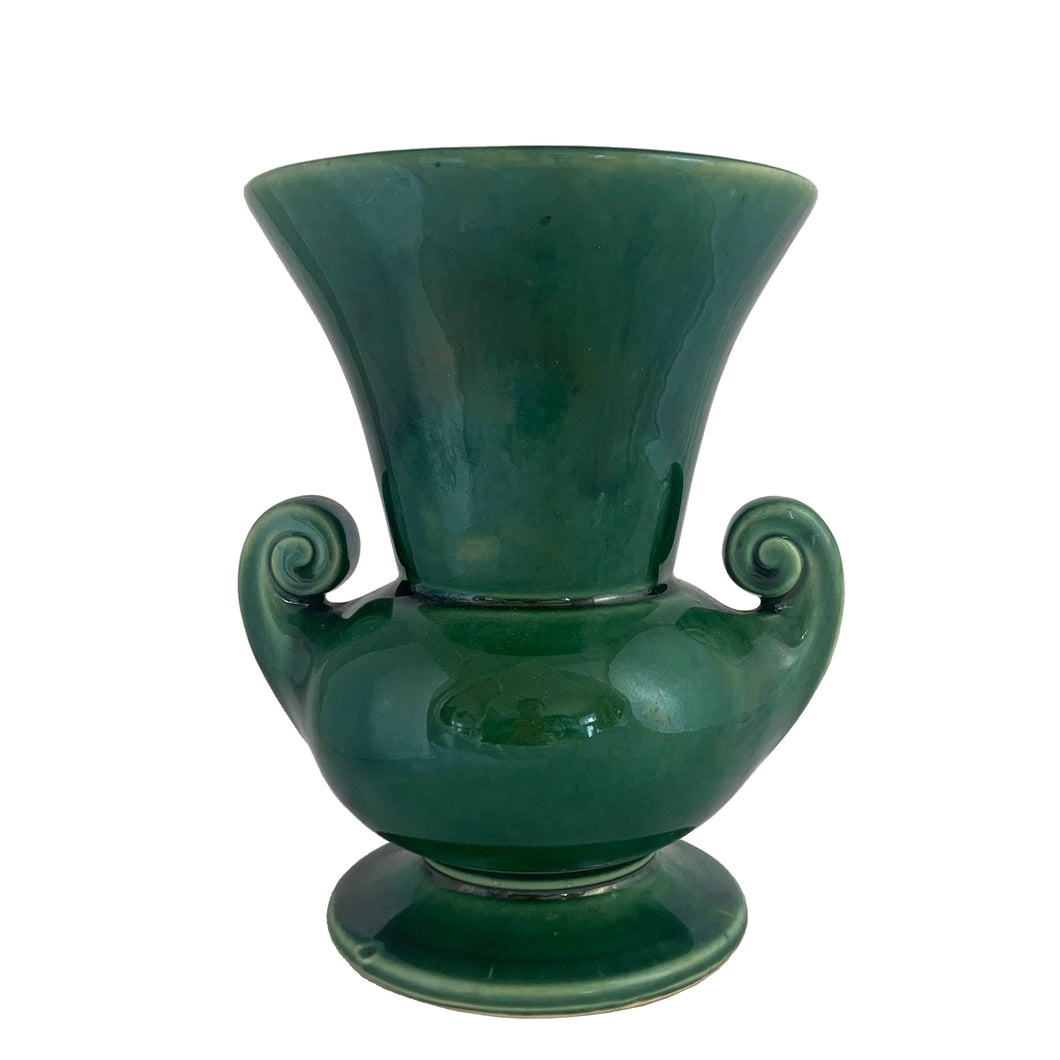 Vintage mid-century gloss green trumpet vase with curled handles. Crafted by McCoy Pottery, late 1950s. This lovely vase is must for any art pottery collector!

In excellent  condition, no chips/cracks/repairs, crazing commensurate with age, typical manufacturing glaze pops. Maker's mark on the bottom.

Measures 6 1/4 x 5 7/8 x 8 inches