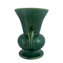 Load image into Gallery viewer, Vintage mid-century gloss green trumpet vase with curled handles. Crafted by McCoy Pottery, late 1950s. This lovely vase is must for any art pottery collector!

In excellent&nbsp; condition, no chips/cracks/repairs, crazing commensurate with age, typical manufacturing glaze pops. Maker&#39;s mark on the bottom.

Measures 6 1/4 x 5 7/8 x 8 inches
