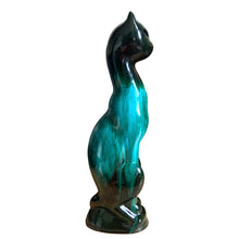 Load image into Gallery viewer, Large vintage retro green drip glaze cat redware pottery figurine or TV lamp, featuring open eyes and hole at the tale for a lighting cord or incense. Crafted by Canadian Ceramic Craft (CCC), Canada, circa 1960s. Add this very cool cat to your collection. For an extra spooky look for your Halloween decor, put a tiny light inside to make the eyes glow!

In excellent condition, no chips/cracks/repairs.

Measures 5 5/8 x 3 3/8 x 17 1/2 inches
