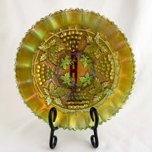 Load image into Gallery viewer, Here is a superb example of an antique Grape and Cable green carnival glass bowl featuring a basketweave pattern on the exterior, a smooth sawtooth ruffled pie crust edge, plus a collar base. The iridescence is fantastic! Crafted by Northwood Glass Company, USA, circa early 1900s. In excellent condition, free from chips/cracks. Marked on the bottom with Northwood N with underline inside a circle. Measures 8 3/8 x 2 1/4 inches
