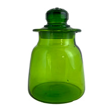 Load image into Gallery viewer, Vintage hand blown green art glass apothecary jar with flower lid. Takahashi Glass, Japan, circa 1970. Perfect for food storage, or home decor. This fabulously happy colour will liven up any room, especially in a bright window! Good vintage condition with minor flea bite on the inside rim of the lid. Typical manufacturing imperfections in the glass such as bubbles and stringers. Measures 4 x 6 inches
