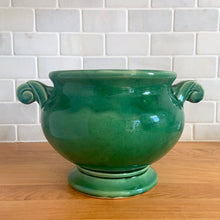Load image into Gallery viewer, Highly collectible vintage mid-century green Art Deco round ceramic art pottery jardiniere planter with curled handles. Crafted by McCoy Pottery, USA, 1950s. The perfect home for your favourite houseplant or succulent!

In excellent vintage condition, no chips/cracks/repairs, age-related crazing. Maker&#39;s mark.

Measures 6 3/4 x 6 inches (10 1/4 inches from handle-to-handle)
