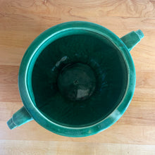 Load image into Gallery viewer, Highly collectible vintage mid-century green Art Deco round ceramic art pottery jardiniere planter with curled handles. Crafted by McCoy Pottery, USA, 1950s. The perfect home for your favourite houseplant or succulent!

In excellent vintage condition, no chips/cracks/repairs, age-related crazing. Maker&#39;s mark.

Measures 6 3/4 x 6 inches (10 1/4 inches from handle-to-handle)
