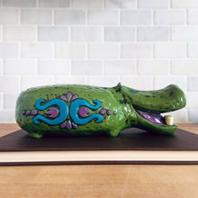 Load image into Gallery viewer, Adorable vintage happy green hippopotamus coin bank. This smiling hippo has white teeth, purple tongue and is embossed with a colourful fun on either side in blue and purple. Crafted by Pride Creations Inc. USA and made in Japan, 1970s. Makes a great retro decor piece for a nursery or child&#39;s bedroom or playroom!

In good vintage condition, no chips or cracks. No rubber stopper.

Measures 10 x 3 3/4 x 3 inches
