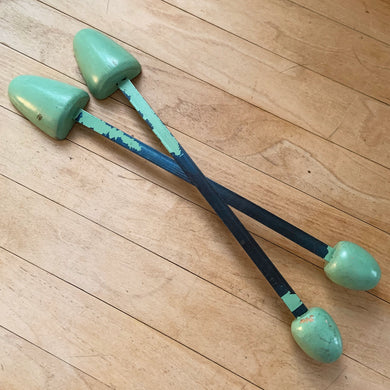 Vintage pair of ladies wood and metal shoe stretchers in pale green. These feature wood ends between a flexible metal strap. Perfect to help your shoes retain their original shape, use as decor or as a prop. Circa 1950s.  In good vintage condition with minor age-related wear.  Measures approximately 11 1/2 inches long