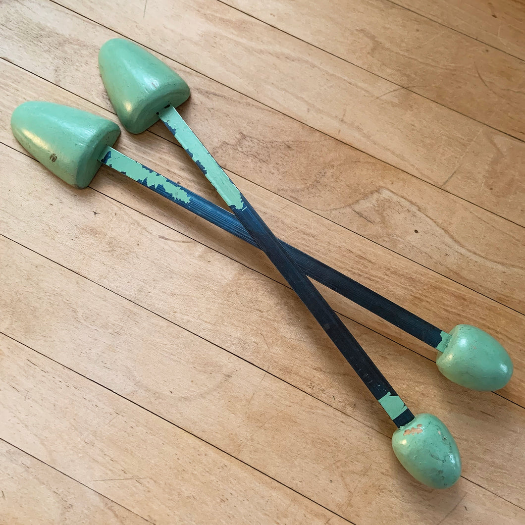 Vintage pair of ladies wood and metal shoe stretchers in pale green. These feature wood ends between a flexible metal strap. Perfect to help your shoes retain their original shape, use as decor or as a prop. Circa 1950s.  In good vintage condition with minor age-related wear.  Measures approximately 11 1/2 inches long