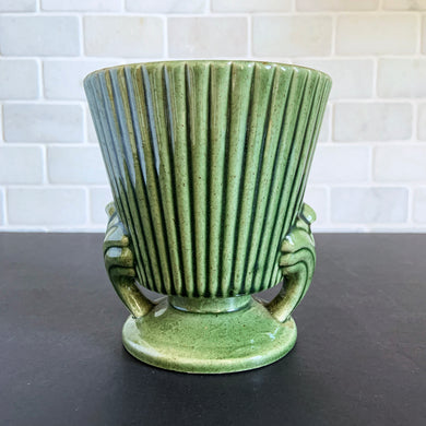 Vintage green ribbed ceramic pedestal planter with decorative handles. Another beautiful piece of pottery crafted by Royal Haeger, USA, circa 1970s. Pop in your favourite houseplant or succulents and enjoy!  In excellent condition, free from chips/cracks/repairs. Marked on the bottom.  Measures 5 1/2 inches