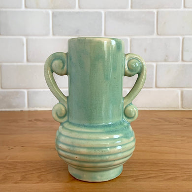 Rare vintage art deco Coronado Art Line pale green vase with double curled handles, 4A. Crafted by Brush McCoy Pottery, 1940s. This unique vase is a must-have for any art pottery collector. A lovely piece to use in your home decor or to give as a gift!

In excellent vintage condition, no chips/cracks/repairs. Marked on the bottom, A4 USA.

Measures 3 1/2 x 4 5/8 inches (incl. handles)